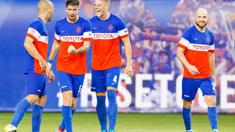 FC Cincinnati players celebrate their 1-0 victory over the Columbus Crew after their Open Cup match, held at Nippert Stadium on the campus of the University of Cincinnati, Wednesday, June 14, 2017. GREG LYNCH / STAFF