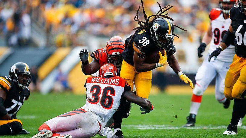 PITTSBURGH, PA - SEPTEMBER 18: Daryl Richardson #38 of the Pittsburgh Steelers is tackled by Shawn Williams #36 of the Cincinnati Bengals in the first half during the game at Heinz Field on September 18, 2016 in Pittsburgh, Pennsylvania. (Photo by Justin K. Aller/Getty Images)