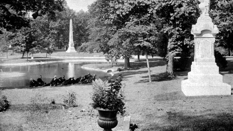 A group of men lounge at the edge of a lake at Woodland Cemetery. Woodland Cemetery and Arboretum is one of the nation's oldest garden cemeteries. WRIGHT STATE UNIVERSITY SPECIAL COLLECTIONS AND ARCHIVE
