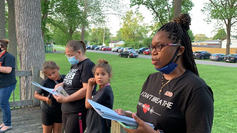 Huber Heights residents sing ‘Lift Every Voice and Sing,’ the hymn often referred to as the Black national anthem at a celebration of Black lives on the one-year anniversary of George Floyd's death.