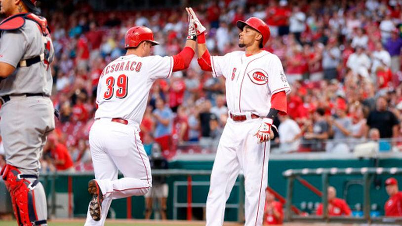CINCINNATI, OH - SEPTEMBER 9: Devin Mesoraco #39 of the Cincinnati Reds is congratulated by Billy Hamilton #6 after hitting a two-run home run in the first inning of the game against the St. Louis Cardinals at Great American Ball Park on September 9, 2014 in Cincinnati, Ohio. (Photo by Joe Robbins/Getty Images)