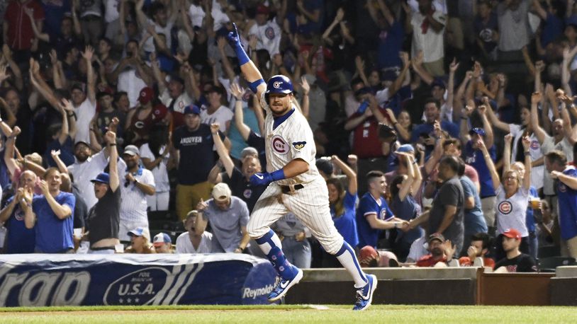 CHICAGO, ILLINOIS - JULY 16: Kyle Schwarber #12 of the Chicago Cubs celebrates his walk off home run against the Cincinnati Reds during the tenth inning at Wrigley Field on July 16, 2019 in Chicago, Illinois. (Photo by David Banks/Getty Images)