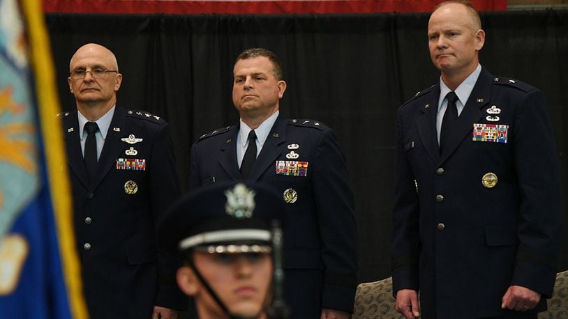 Brig. Gen. Michael Schmidt (right) takes leadership of the Command, Control, Communications, Intelligence and Networks directorate at Hanscom Air Force Base, Mass., April 13 from Maj. Gen. Dwyer Dennis (center), who is retiring, during a ceremony hosted by Lt. Gen. Arnold Bunch (left), military deputy of the Office of Assistant Secretary of Air Force for Acquisition at the Pentagon. The change of leadership ceremony was held at the Hanscom Aero Club hangar. (U.S. Air Force photo/Linda LaBonte Britt)