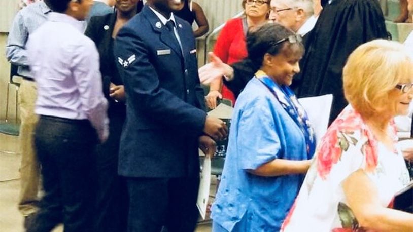 Senior Judge Walter Rice of the federal Southern District of Ohio swears in Airman 1st Class Gerald Nyabaro, who renounced his Kenyan citizenship so he could achieve his dream of becoming a U.S. citizen. A ceremony was conducted at a naturalization ceremony in Dayton the afternoon of Sept. 6. (Courtesy photo)