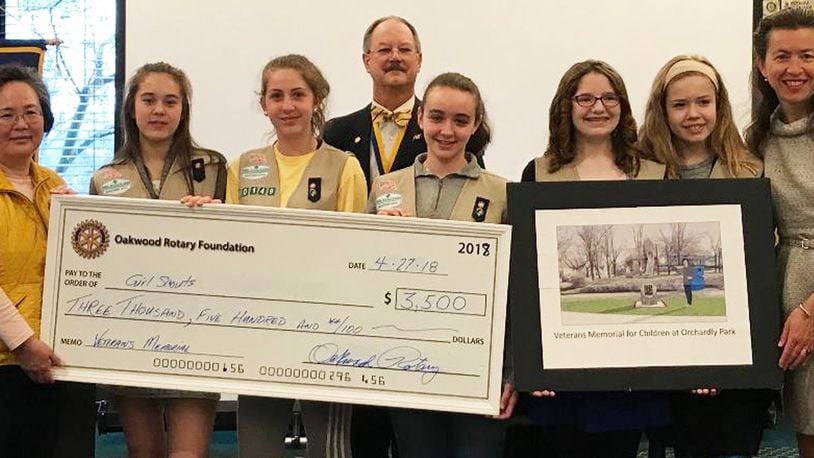 After presentation at Rotary, scouts are presented with check to help cover costs of veterans memorial: (left to right) Scout leader Mayumi Hall, Sarah Hall, Sarah Harris, Mr. Rick DaPrato of the Oakwood Rotary Foundation, Isabel Rubin-Alvarez, Lizzi Clock, and Azalea Biteau. CONTRIBUTED.