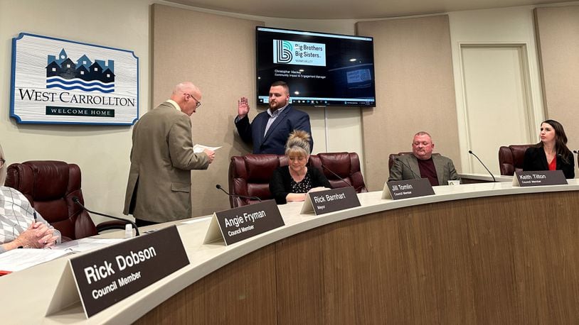 West Carrollton Mayor Rick Barnhart (left) administers the oath of office to Michael Boyle (right) during a West Carrollton City Council meeting Tuesday, Feb. 13, 2024. Boyle fills a seat vacated by Barnhart, who was elected mayor in November. CONTRIBUTED