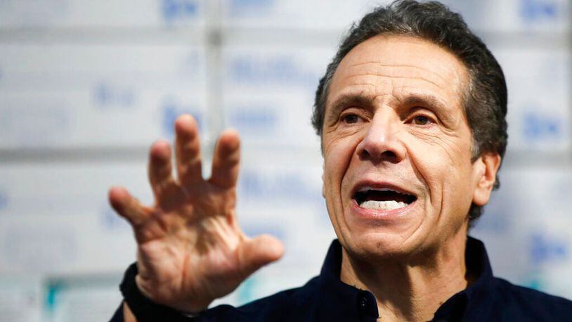 In this March 24, 2020 photo, New York Gov. Andrew Cuomo speaks during a news conference against a backdrop of medical supplies at the Jacob Javits Center that will house a temporary hospital in response to the COVID-19 outbreak in New York.