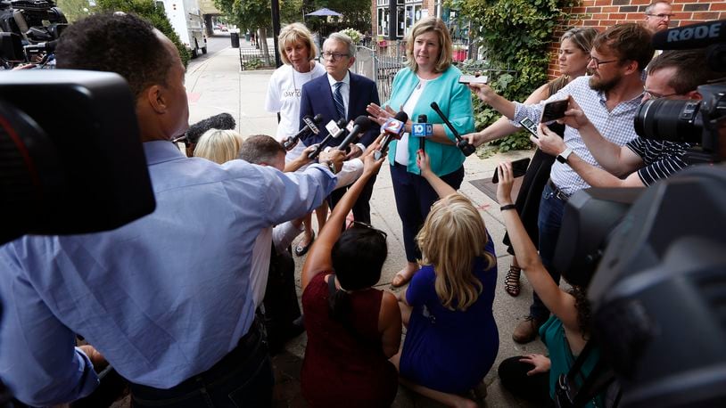 Ohio Governor Mike Dewine and Dayton Mayor Nan Whaley are among Ohio politicians seeking gun legislation that addresses more than mass shooting threats. Here the two spoke Aug. 8 in the Oregon District. TY GREENLEES / STAFF