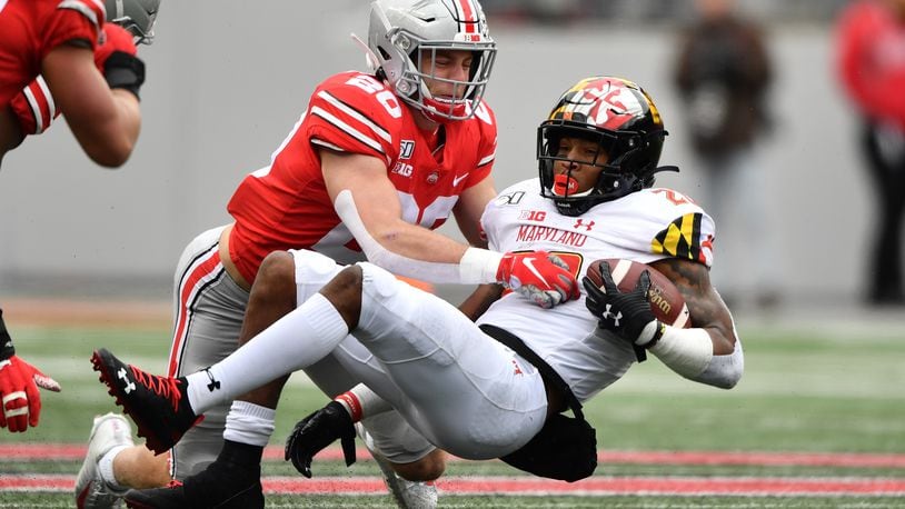COLUMBUS, OH - NOVEMBER 9:  Pete Werner #20 of the Ohio State Buckeyes tackles Javon Leake #20 of the Maryland Terrapins after a short gain in the second quarter at Ohio Stadium on November 9, 2019 in Columbus, Ohio.  (Photo by Jamie Sabau/Getty Images)