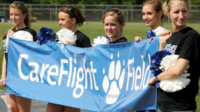 This 2007 file photo shows Springboro cheerleaders holding a banner with the name CareFlight Field, the new name of their football stadium. Now, the district is working on a new naming-rights deal.