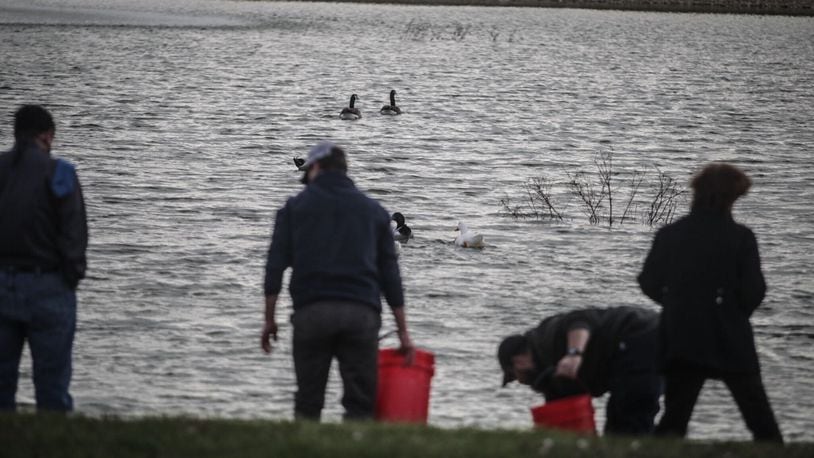 Miami Twp. employees restock the pond at Miami View Park in November 2020. JIM NOELKER/STAFF