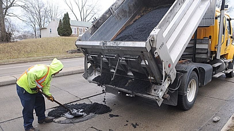 Local officials say potholes are worse this year than the past two winters. A Dayton crew patches a pothole on Gettysburg Ave. MARSHALL GORBY