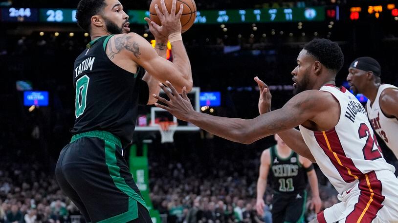 Boston Celtics forward Jayson Tatum (0) looks to pass while pressured by Miami Heat forward Haywood Highsmith (24) during the first half of Game 5 of an NBA basketball first-round playoff series, Wednesday, May 1, 2024, in Boston. (AP Photo/Charles Krupa)
