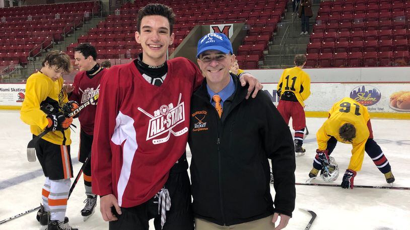 Gutterman (right) with his son Cole at the Southwest Ohio High School League All Star game, sponsored by the Academy Hockey Club.