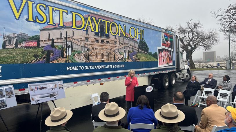 Jacquelyn Powell, president and CEO of the Dayton Convention & Visitors Bureau, speaks at an event where the third semi-trailer with images promoting Dayton was unveiled. The truck is likely to travel about 100,000 miles all over the country each year. CORNELIUS FROLIK / STAFF