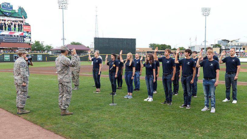 Col. Bradley McDonald, 88th Air Base Wing commander, administers the oath of enlistment at Fifth Third Field in downtown Dayton Aug. 5 to members of the delayed enlistment program as Chief Master Sgt. Kathlina Racine, 88 ABW command chief, watches. (U.S. Air Force photo/Wesley Farnsworth)