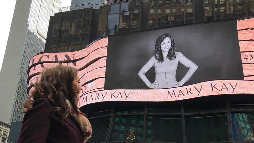 Frantz was featured on a Mary Kay billboard in Times Square in New York City. She is shown looking at her image on the digital board.
