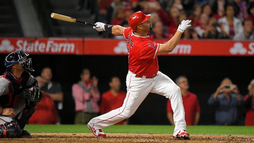 Los Angeles Angels' Albert Pujols, right, follows through on a grand slam, the 600th homer of his career, as Minnesota Twins catcher Chris Gimenez watches during the fourth inning of a baseball game Saturday, June 3, 2017, in Anaheim, Calif. (AP Photo/Mark J. Terrill)