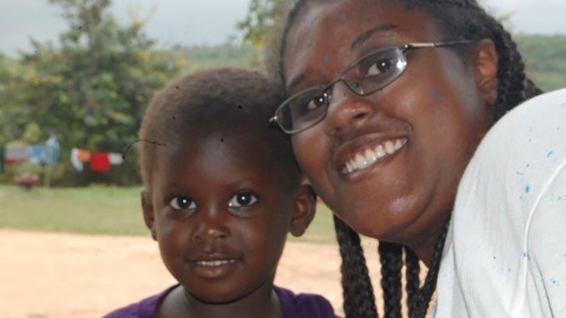 After painting outside of orphanage in Ghana, Africa, in 2008, Breanna McGowan poses with orphan Zahara. (Courtesy photo)