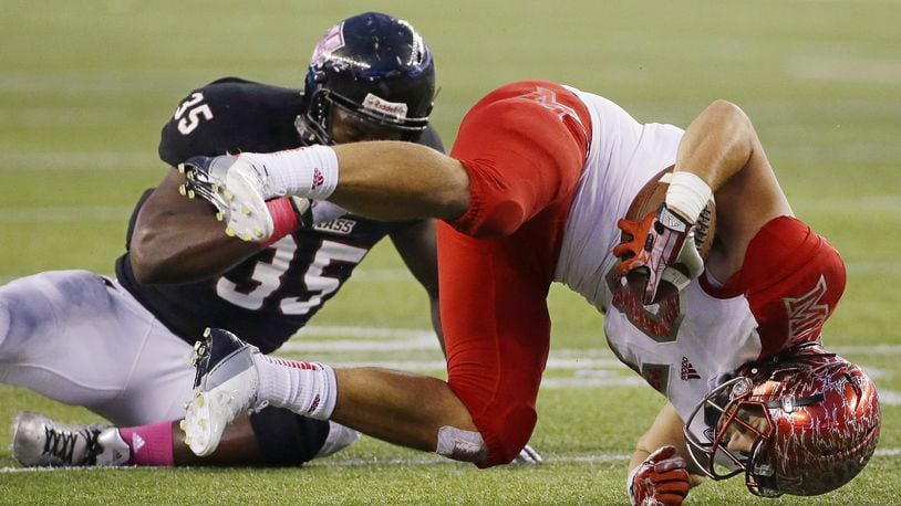 Miami tight end Steve Marck, right, falls after being hit by Massachusetts defensive lineman Stanley Andre (35) during the fourth quarter of an NCAA college football game in Foxborough, Mass., Saturday, Oct. 12, 2013. Massachusetts 17-10. (AP Photo/Stephan Savoia)