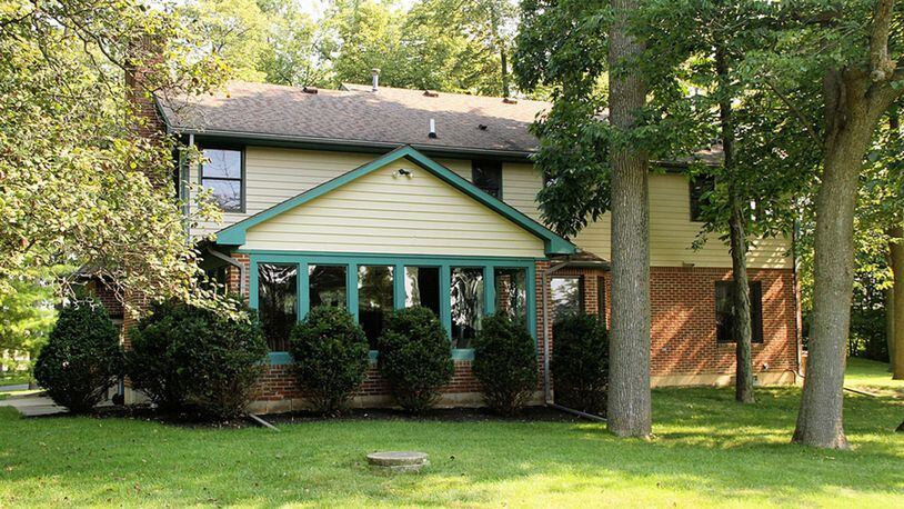 A screen-enclosed porch is accessible from the family room, which has a brick, wood-burning fireplace. The porch has a ceiling paddle fan and carpeting. The basement has been finished into a recreation room, a bonus room and a full bathroom.