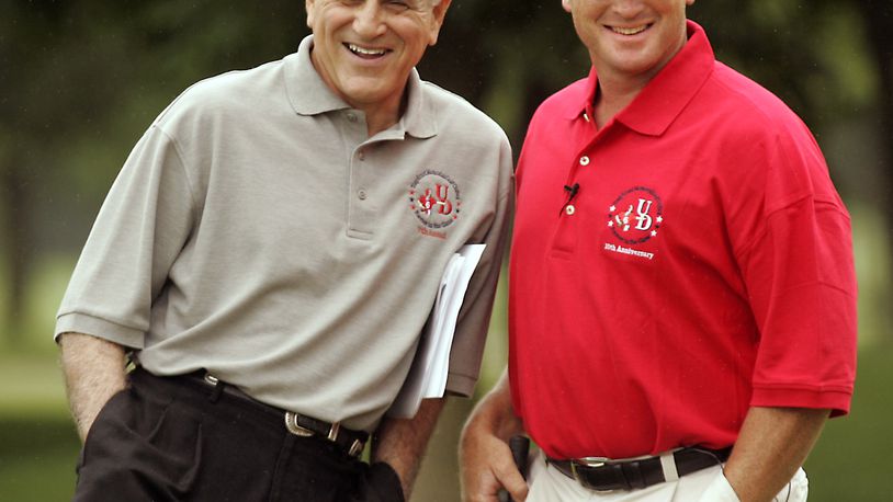 Former UD football coach Mike Kelly (L) and NFL TV analyst and former Super Bowl-winning coach Jon Gruden enjoy a light moment Friday on the course. Gruden provided celebrity to UD's annual golf outing, the Tony Ernst Memorial Golf Club at Yankee Trace Friday.Staff Photo by Jim Witmer
