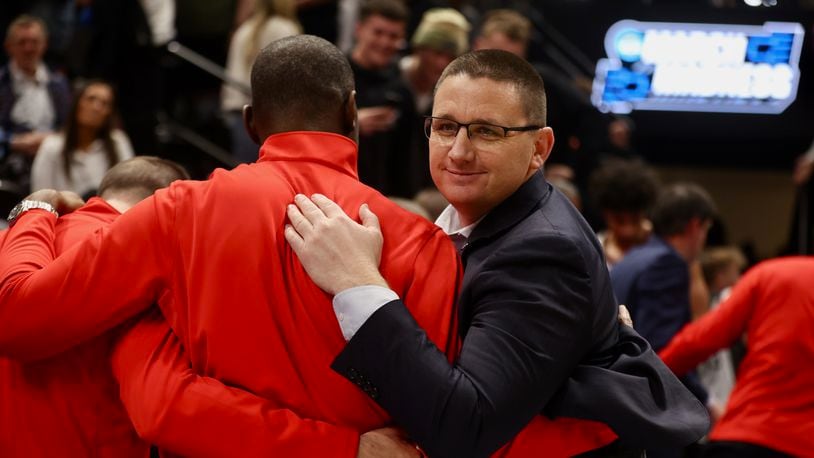 Dayton's Neil Sullivan celebrates with Anthony Grant after a victory against Nevada in the first round of the NCAA tournament on Thursday, March 21, 2024, at the Delta Center in Salt Lake City, Utah. David Jablonski/Staff