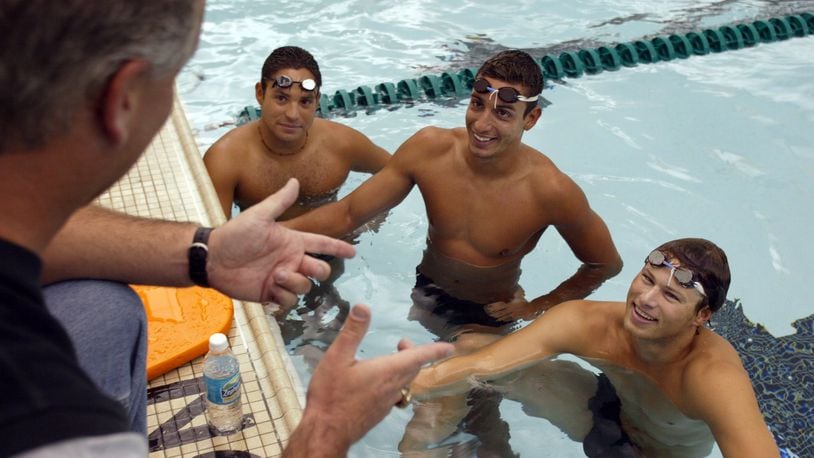 Former Wright State swimmer Rafael Candido (in pool, center), who competed in the 1990s, is among those hoping to save the school’s swimming and diving program from the budget ax. FILE PHOTO
