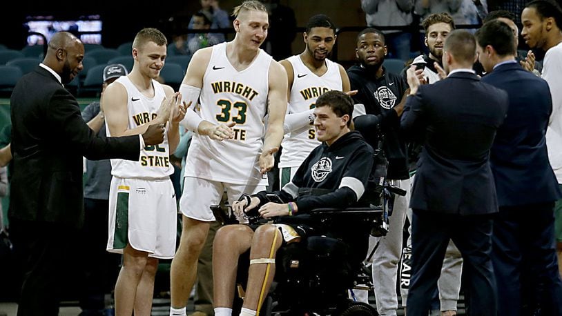 Ryan Custer is congratulated by teammates during senior recognition after Wright State’s game against IUPUI at the Nutter Center in Fairborn on Sunday, Feb. 16, 2020. Contributed photo by E.L. Hubbard