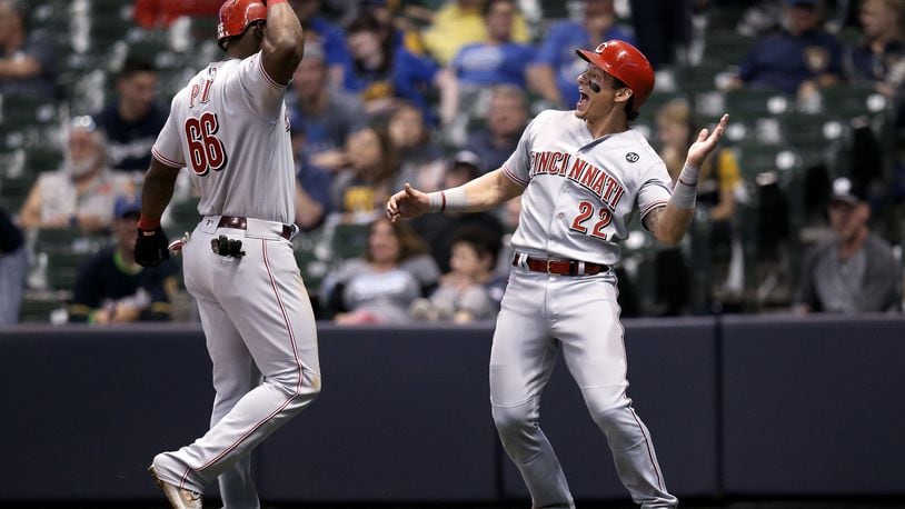 MILWAUKEE, WISCONSIN - JUNE 21:  Yasiel Puig #66 and Derek Dietrich #22 of the Cincinnati Reds celebrate after Puig hit a home run in the eighth inning against the Milwaukee Brewers at Miller Park on June 21, 2019 in Milwaukee, Wisconsin. (Photo by Dylan Buell/Getty Images)