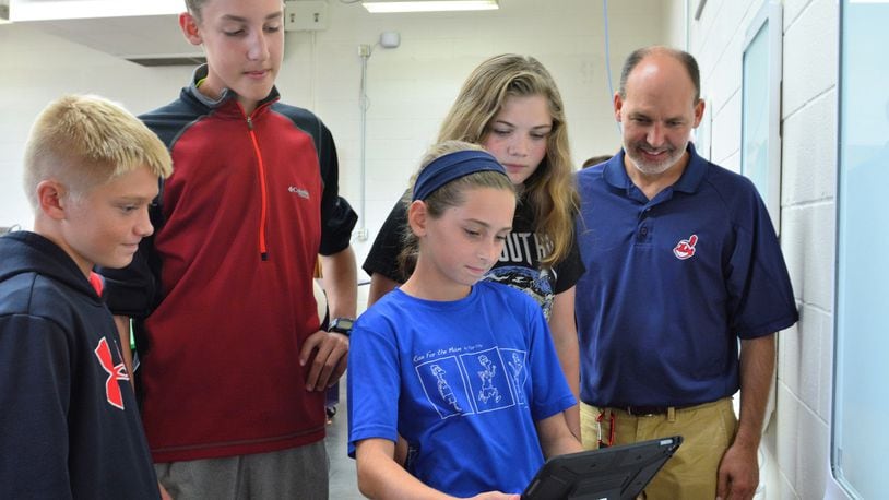 Students in the Tipp City Design Thinking class prepare to write their ideas to the latest class challenge on a smart board. Pictured (from left): students Peyton Taylor, Ben Prenger, Ava Newbourn and teacher Dale Bonifas. In front is Mia Larned. CONTRIBUTED