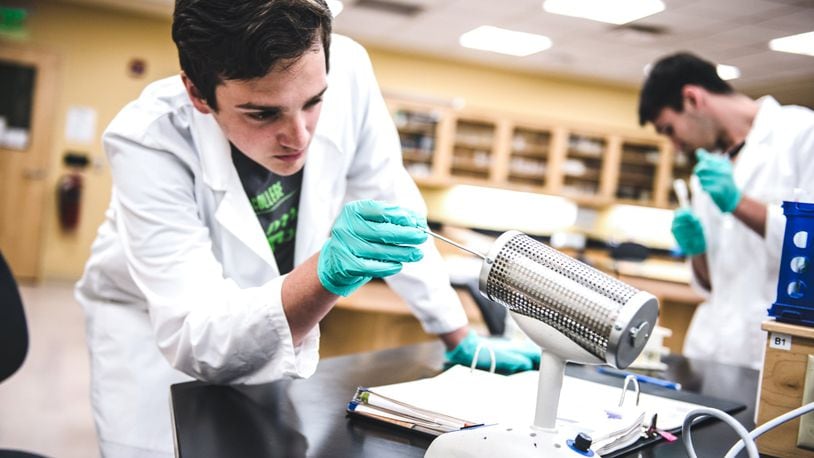 Human biology student Ryan Lafave works on how to utilize a piece of equipment in a laboratory at Kettering College. (Photo by Scott Robins)