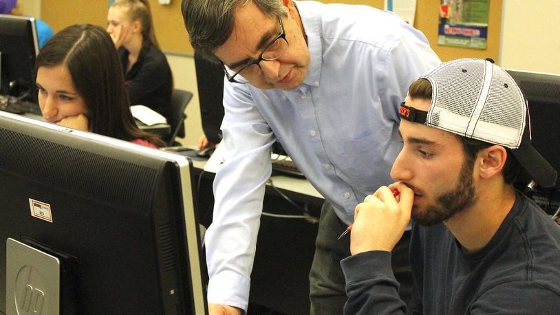 Wittenberg professor, Ron Taylor helps a student in a computer science class. JEFF GUERINI/STAFF
