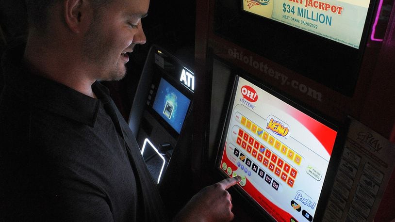 Matthew L. Adair plays a KENO game on Thursday Aug. 18, 2022 at Romer's Bar & Grill in Bellbrook. Starting in January, Ohioans will be able to place sports bets at kiosks similar to this one, at state-approved locations. Romer's is among 86 pre-approved sites in the Dayton area. MARSHALL GORBY\STAFF