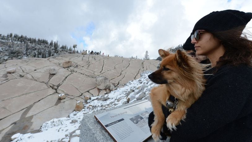 Niki Cloyd, of Los Angeles, and her dog Izzy take in the view on Thursday, Sept. 21, 2017 from Olmsted Point in northern Yosemite National Park in the central Sierra Nevada mountains of California. (Dan Honda/Bay Area News Group/TNS)