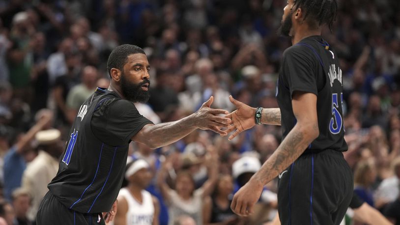 Dallas Mavericks guard Kyrie Irving (11) congratulates forward Derrick Jones Jr. (55) during the second half of an NBA basketball first-round playoff series against the Los Angeles Clippers Friday, May 3, 2024, in Dallas. (AP Photo/Jeffrey McWhorter)