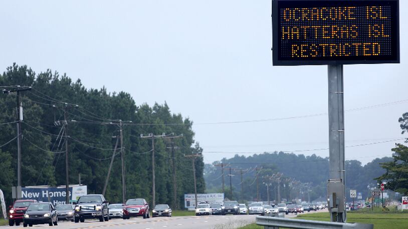 A sign in Moyock, N.C., warns travelers that access to both Hatteras and Ocracoke Islands is restricted to residents only on Saturday, July 29, 2017.   A power outage that drove tourists from two North Carolina islands wiped out a significant chunk of the lucrative summer months for local businesses.  Business owners were upset that the disaster was caused by human error, not Mother Nature. The construction company drove a steel casing into an underground transmission line, causing blackouts on Ocracoke and Hatteras islands. (Steve Earley /The Virginian-Pilot via AP)