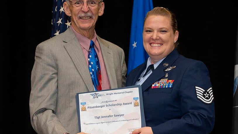 Tech Sgt. Jennafer Sawyer receives the Pitsenbarger Scholarship on June 15 from Air and Space Forces Association Wright Memorial Chapter during the Community College of the Air Force Spring 2022 graduation ceremony at the National Museum of the Air Force. The scholarship is a cash award to be used in the continuation of education beyond the associate degree level. U.S. AIR FORCE PHOTO/R.J. ORIEZ