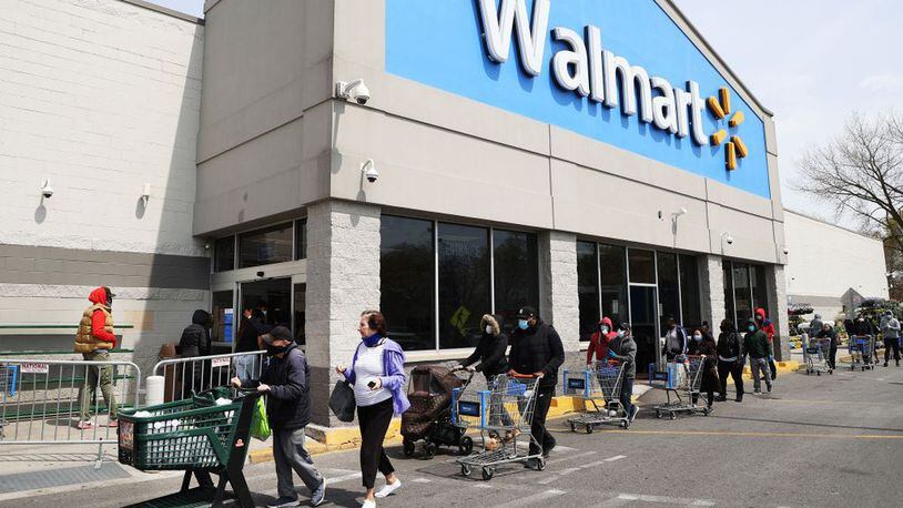 FILE PHOTO: Employees at Walmart are required to wear a face mask or other face covering while working, company officials said Friday. (Al Bello/Getty Images)