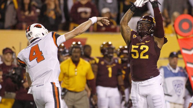TEMPE, AZ - NOVEMBER 16: Quarterback Sean Mannion #4 of the Oregon State Beavers throws a pass as he is pressured by linebacker Carl Bradford #52 of the Arizona State Sun Devils during the first quarter of their college football game at Sun Devil Stadium on November 16, 2013 in Tempe, Arizona. (Photo by Ralph Freso/Getty Images)