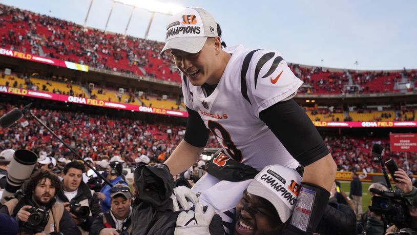 Cincinnati Bengals quarterback Joe Burrow (9) celebrates with teammate Tyler Shelvin at the end of the AFC championship NFL football game against the Kansas City Chiefs, Sunday, Jan. 30, 2022, in Kansas City, Mo. The Bengals won 27-24 in overtime. (AP Photo/Charlie Riedel)
