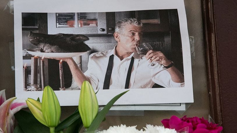 A memorial with flowers, notes, and pictures in memory for the late celebrity chef Anthony Bourdain in front of his former New York restaurant, Brasserie Les Halles, at 411 Park Ave South, in Manhattan, on Friday, June 8, 2018. (Shawn Inglima/New York Daily News/TNS)