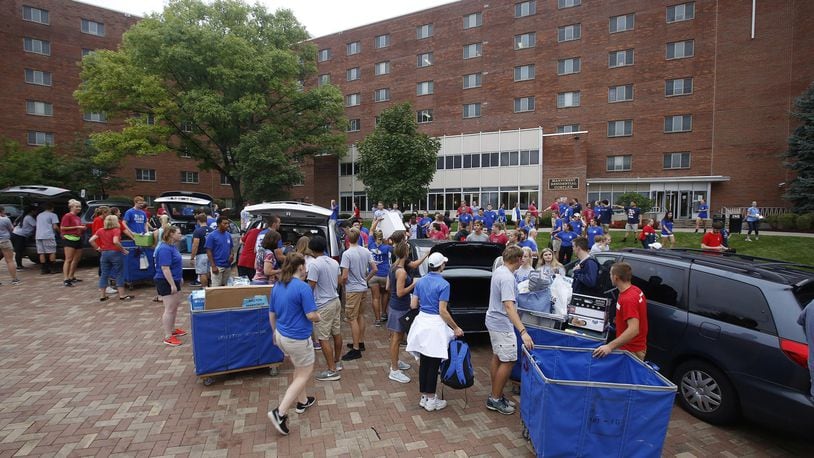 Scene from move in day 2018 at the University of Dayton. Junior Cordell Stover directs traffic at Marycrest Hall. TY GREENLEES / STAFF