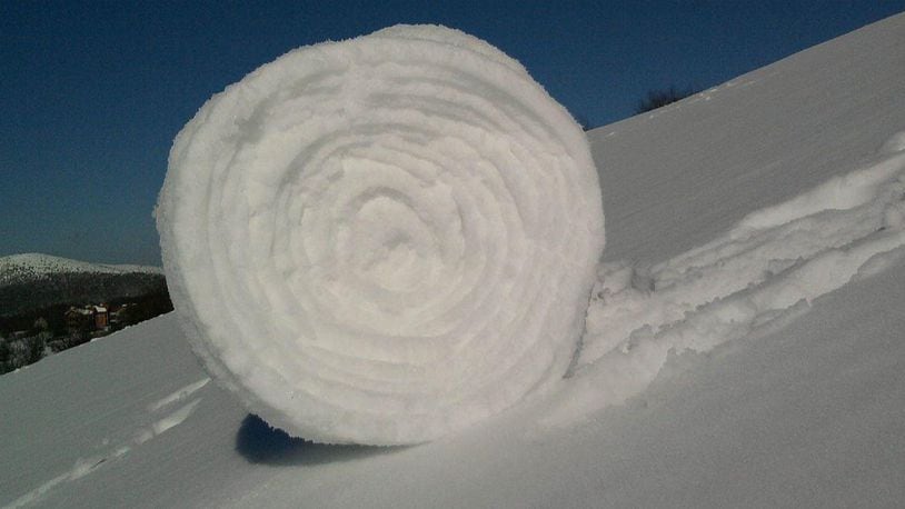 This is a snow roller and a rather large. They form only under perfect conditions involving snow, wind, moisture and temperature.
