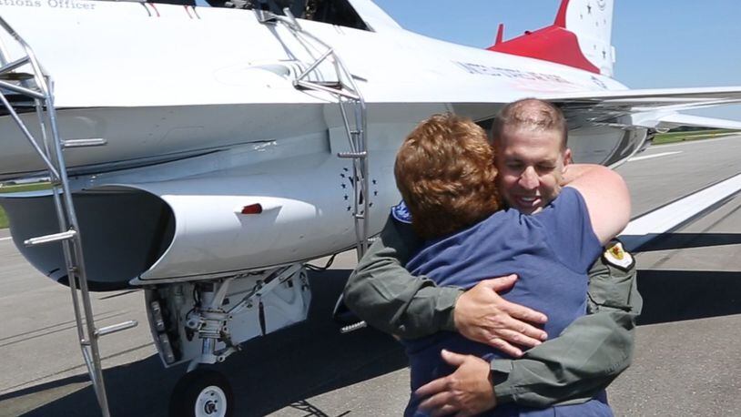Dayton Airport Fire Captain Brian Seidenschmidt hugs his wife Erin after his flight in a Thunderbird F-16 on Friday at the Dayton International Airport before the weekend Dayton Air Show. TY GREENLEES / STAFF