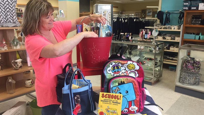 Wright-Patterson Air Force Base Thrift Shop Manager Paula Cardenas prepares a display of back-to-school items in preparation of the shop’s Aug. 17 reopening. (Skywrighter photo/Amy Rollins)