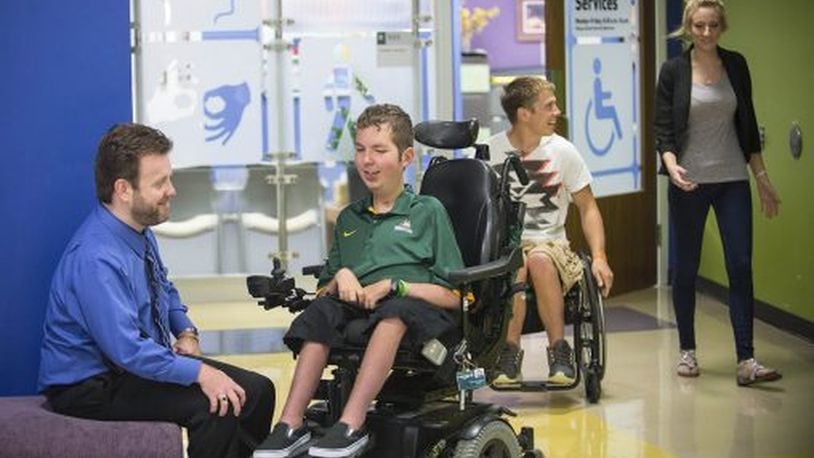 Wright State was recognized as one of the best universities in the nation for students with physical disabilities. Pictured are Tom Webb, left, director of disability services, and Dan Darkow, who graduated from Wright State in 2015. Photo Contributed.