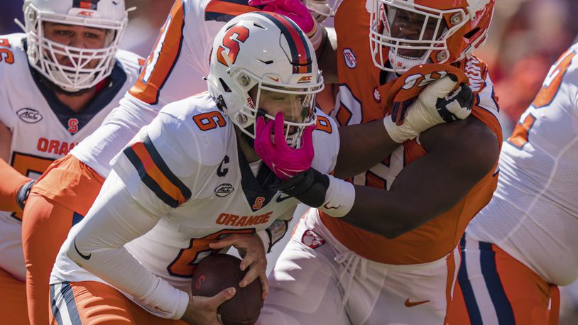 Clemson defensive end Myles Murphy (98) tries to sack Syracuse quarterback Garrett Shrader (6), but was called for a face mask penalty, in the first half during an NCAA college football game on Saturday, Oct. 22, 2022, in Clemson, S.C. (AP Photo/Jacob Kupferman)