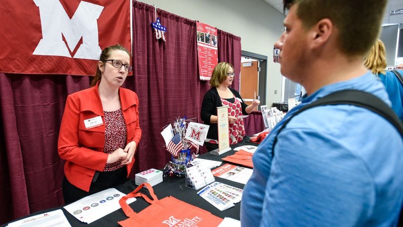 Ruth Orth, Social Media and Communication Specialist for Miami University, explains to some of the course offerings of Miami Regional campuses to Zachary Draut, former student of Middletown High School, during a recruiting event. NICK GRAHAM/STAFF