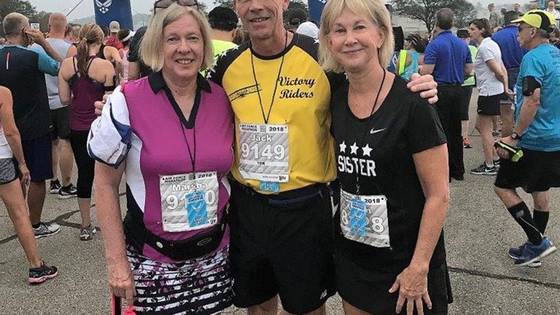 Retired Air Force Lt. Gen. John Hudson (center) poses with his wife and sister at the start of the Air Force Marathon 10K race Sept. 15. Hudson played a key role in helping a man survive a medical incident at mile two of the race through CPR and first aid assistance. (Courtesy photo)